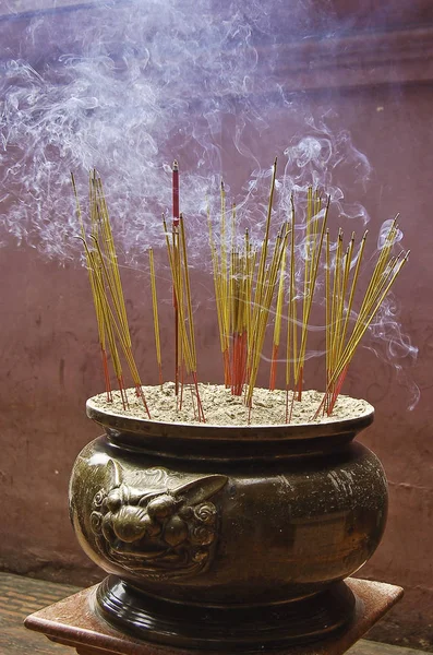 Jar containing incense sticks in a Buddhist temple