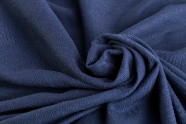 Renkli yün bir örnek. Kumaş dokusuna. Sarmal arka plan. Kumaştan yapılmış bir gül çiçek.