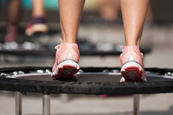 Fitness women jumping on small trampolines,exercise on rebounder