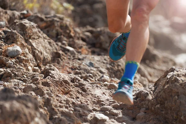 Trail running action close up of running shoes in action