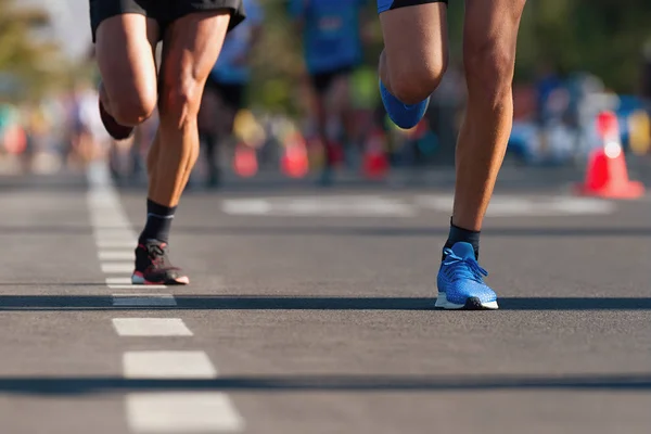 Marathon running race, people feet on city road