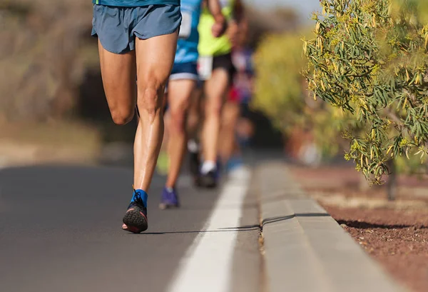 Runners feet running on road close up on shoe