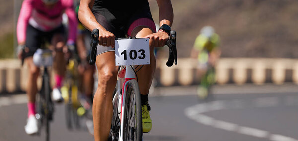 Cycling competition,cyclist athletes riding a race,climbing up a hill on a bicycle