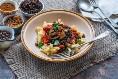 Kushari - Mısır vejetaryen tabağı ile mercimek, kızarmış soğan ile tepesinde makarna ve domates sosu baharatlı