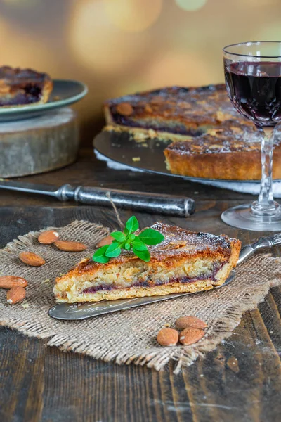 Traditional home baked bakewell tart on rustic wooden table