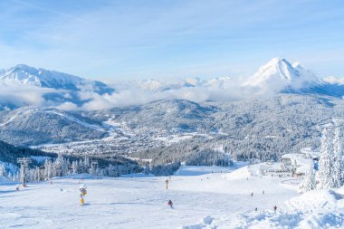 SEEFELD, AUSTRIA - JANUARY 11, 2019: People enjoy skiing on slopes in Seefeld, well known for it's winter sports centres and amongst the most popular tourist resorts in Austria.