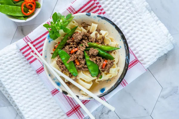 Chinese five-spice beef and sugar snap noodles - top view