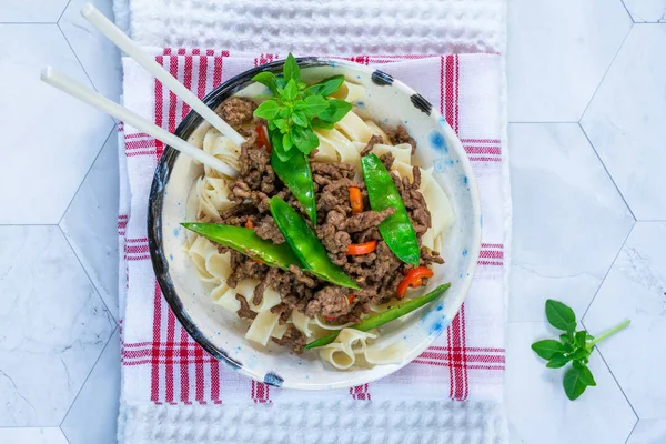 Chinese five-spice beef and sugar snap noodles - top view