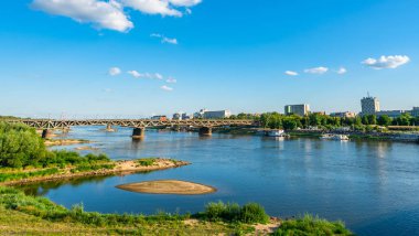 WARSAW, POLAND - JULY 18, 2019: People enjoy hot summer day on the Vistula River Boulevards, one of the most attractive and most frequented public spaces in the city. clipart