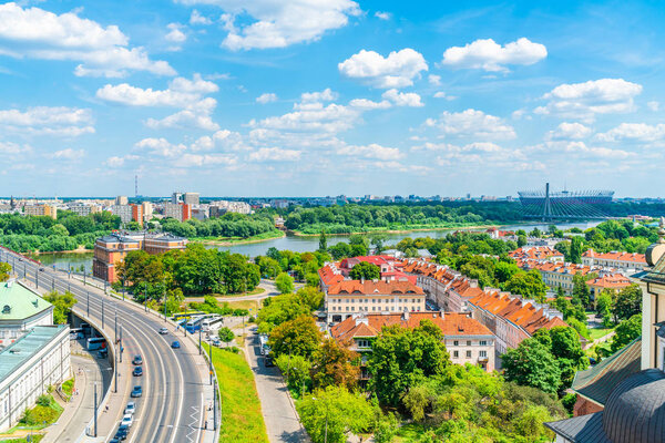 WARSAW, POLAND - JULY 19, 2019: Aerial view of Warsaw cityscape with Vistula River, Swietokrzyski Bridge, National Stadium and Solidarity Avenue - one of the main thoroughfares in Polish capital city