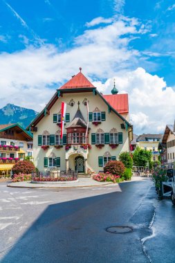 ST. GILGEN, AUSTRIA - JULY 12, 2019: The Rathaus (Town Hall) on Mozartplatz in the Town Centre of Sankt Gilgen village, a populart and well-known travel destination in Salzkammergut region. clipart