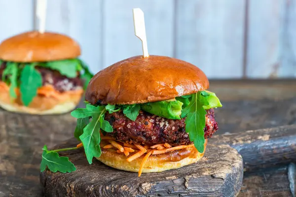 Vegetarian beetroot burger with avocado and carrot slaw in brioche bun