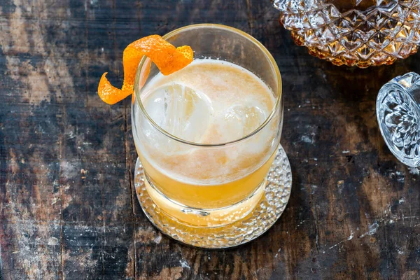 Whiskey sour cocktail with ice cubes