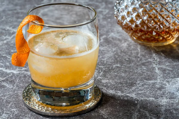 Whiskey sour cocktail with ice cubes