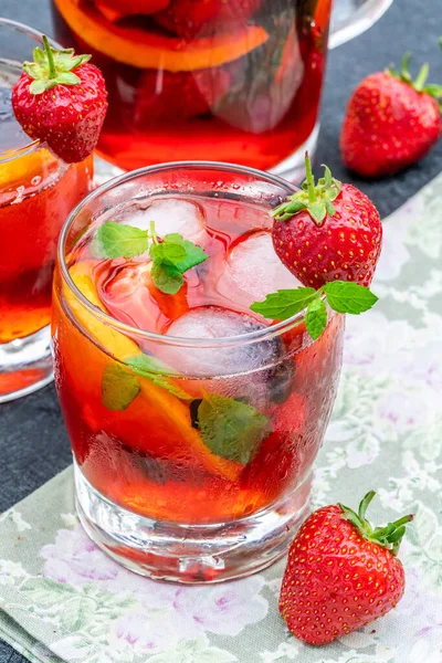 Traditional Pimms cocktail with lemonade, strawberries, cucumber, orange and mint