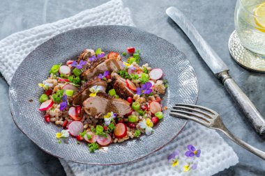 Çıtır ördek, hecelenmiş ve keman çiçekleriyle süslenmiş nar salatası. 