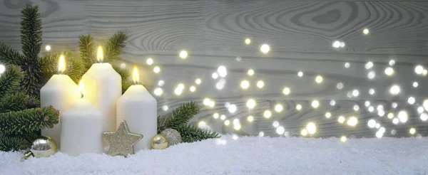 Quatre bougies de l'Avent brûlantes avec décoration dorée et neige blanche . — Photo