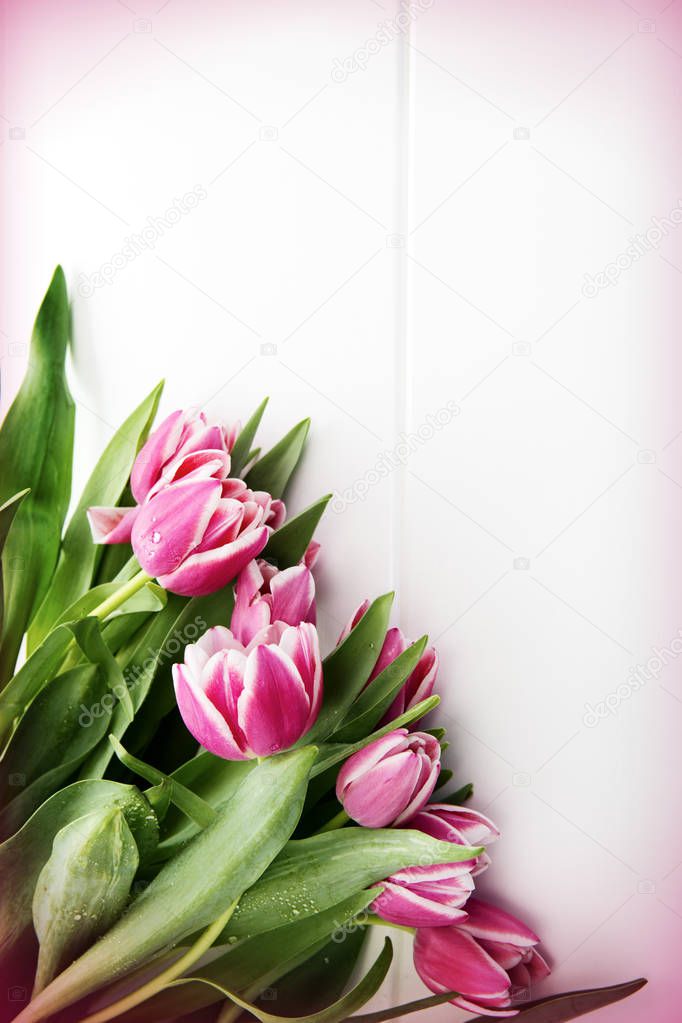Mothers Day card and a bouquet of beautiful tulips on wooden background.