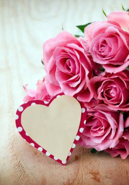 Sevgiliye arka plan ahşap masa üzerinde pembe Güllü.