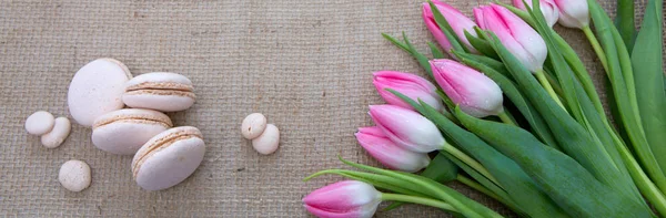 Mothers day background with tulips bouquet and pink macarons. — Stock Photo, Image