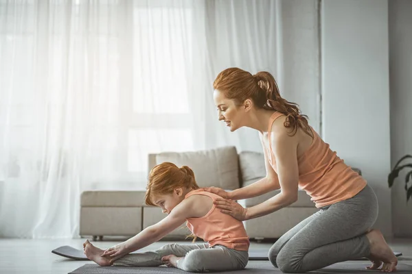 Entrenamiento de madre e hijo pelirrojos en la sala de estar —  Fotos de Stock