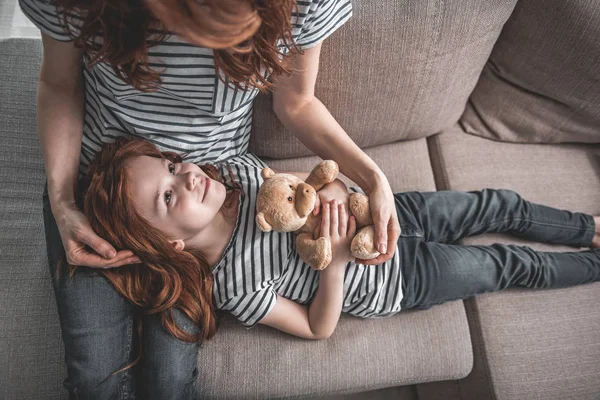 Liten flicka du beundrar hennes mamma på soffan hemma — Stockfoto