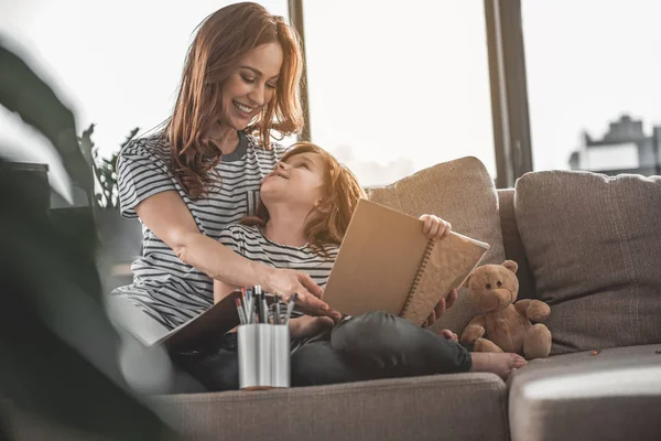 Daughter asking mother opinion about her drawing at home — Stock Photo, Image