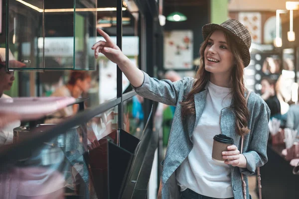 Alegre dama con café cerca de la cafetería para llevar —  Fotos de Stock