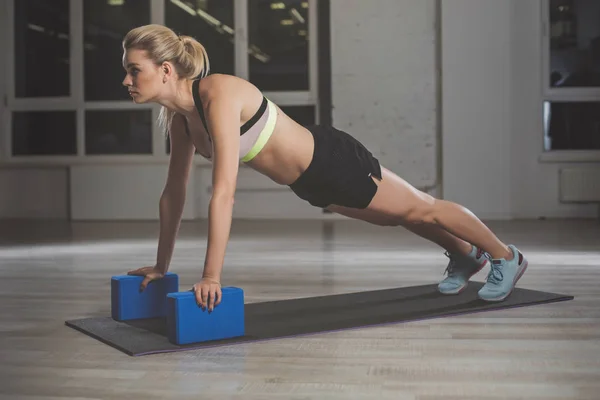 Yoga blokları ile egzersiz genç spor kadın — Stok fotoğraf