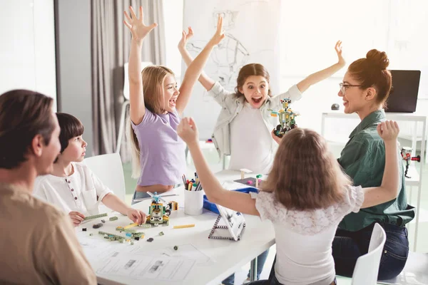 Niños alegres y maestro haciendo juguete de plástico —  Fotos de Stock