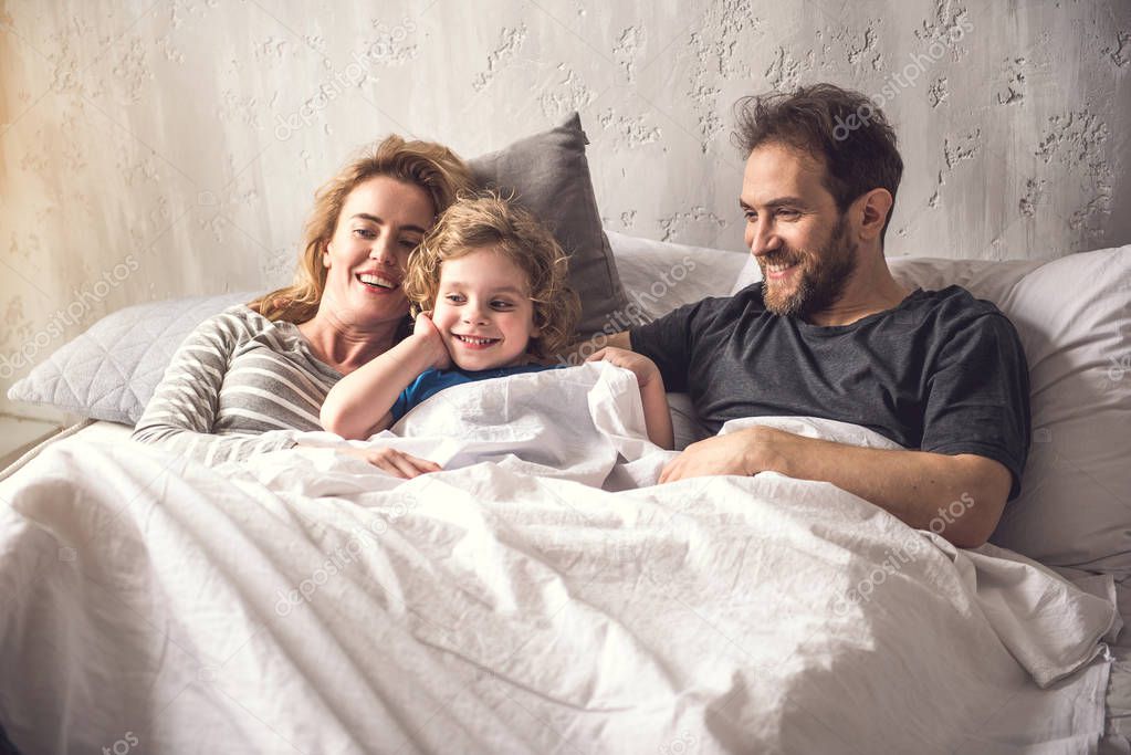 Doting parents are spending morning time with kid