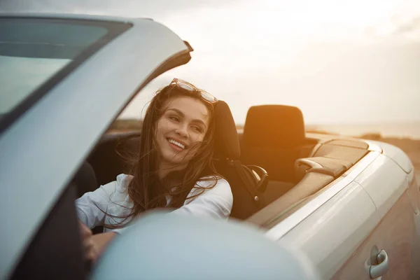 Cheerful pleasant girl is driving auto — Stock Photo, Image
