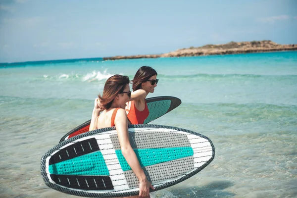 Attractive cheerful women are spending time on beach