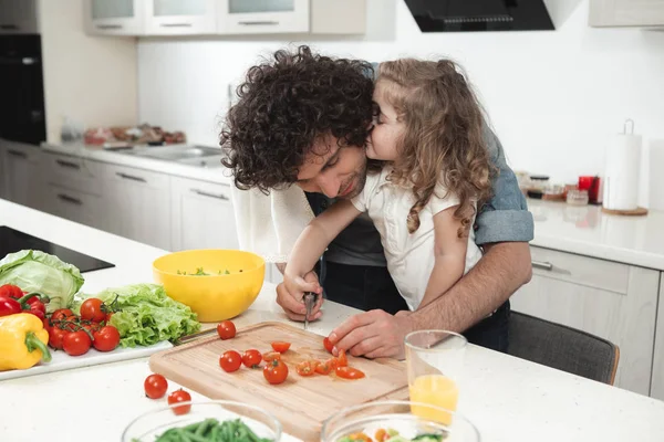 Lovely daughter enjoying food preparation together with her dad — Stock Photo, Image