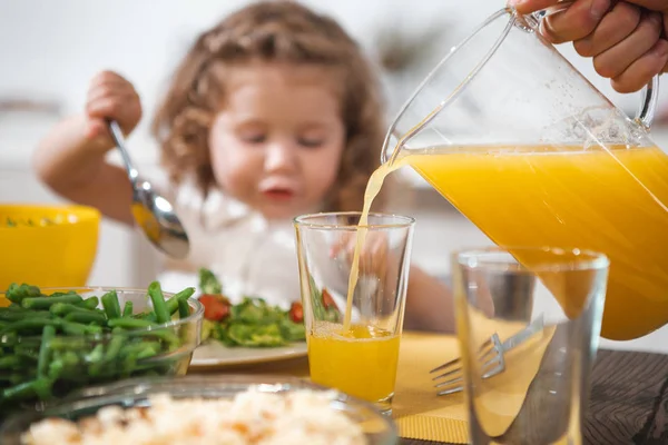 Caring dad giving healthy beverage to his little child — Stock Photo, Image