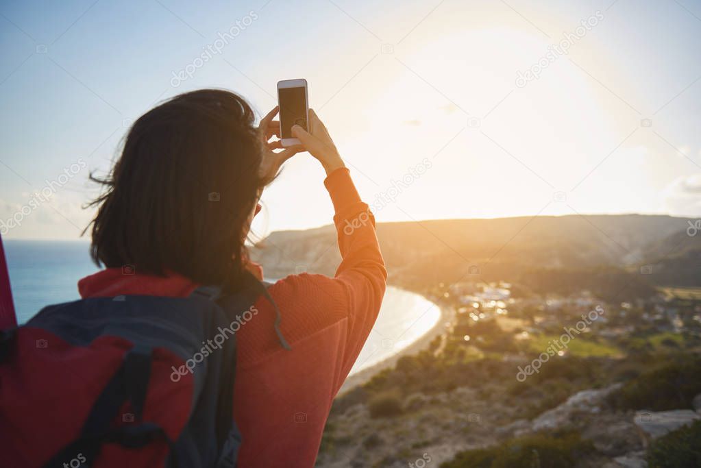 Female tourist making picture of nature