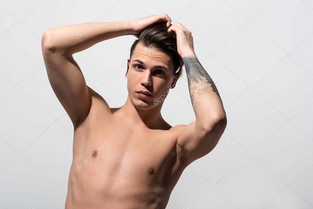 Shirtless attractive guy is posing pensively