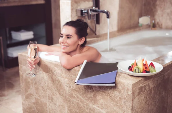 Relaxing woman taking bath in spa