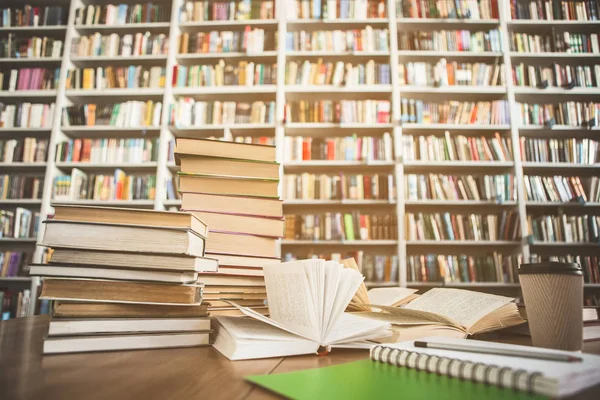 Libros ubicados en mesa y estantes —  Fotos de Stock