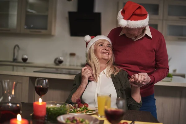 Loving smiling couple at festive dinner for Christmas