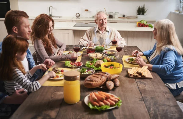Delightful family eating together in kitchen — Stock Photo, Image