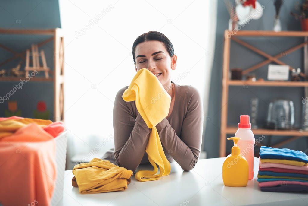 Content woman with yellow t-shirt at home