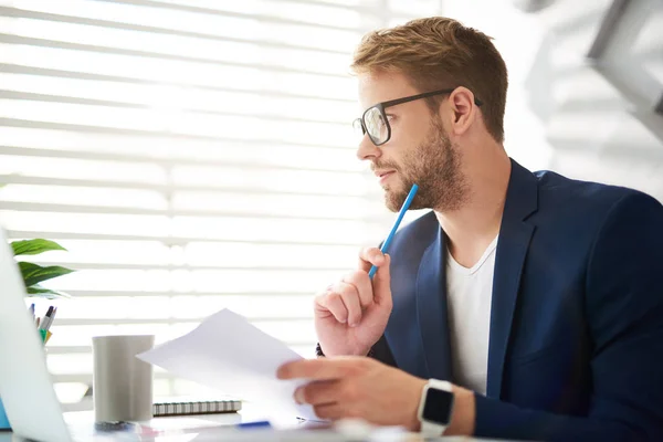 Pensive man distracted at work — Stock Photo, Image