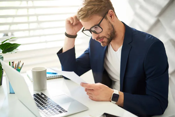 Attentive man checking documents in office — Stock Photo, Image