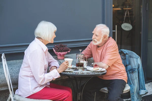 Зрелая пара, общающаяся в кафе на улице — стоковое фото