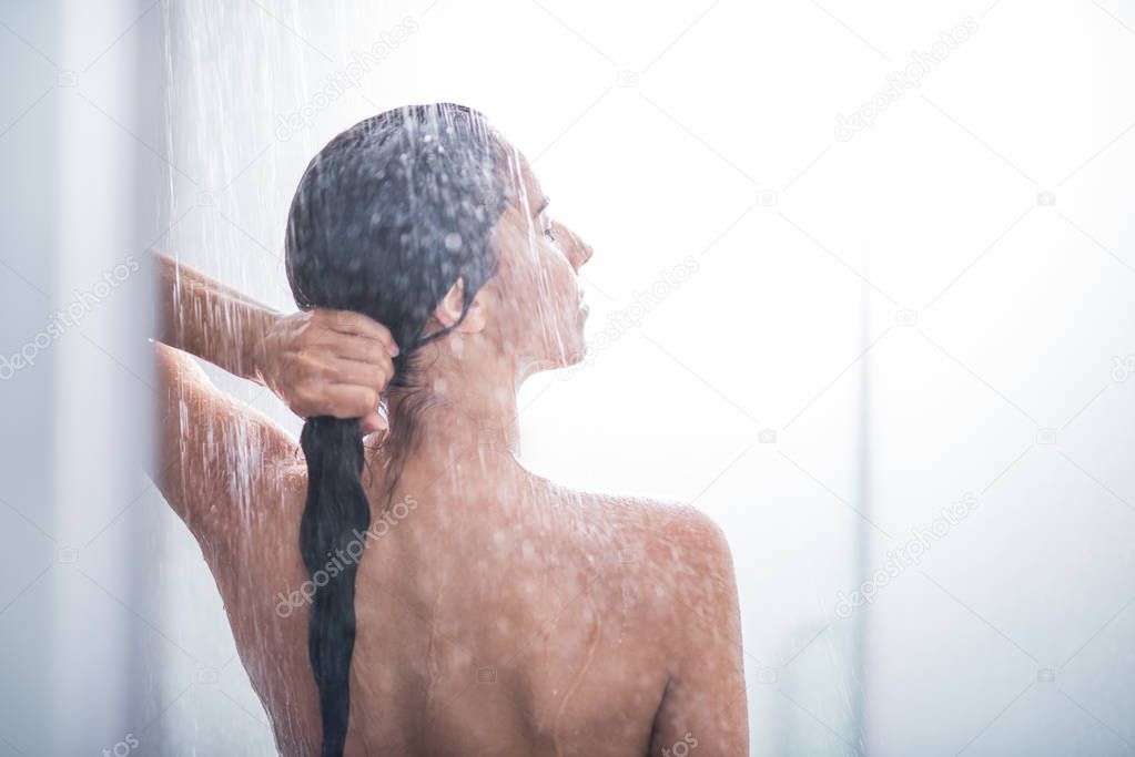 Serene female enjoying warm shower
