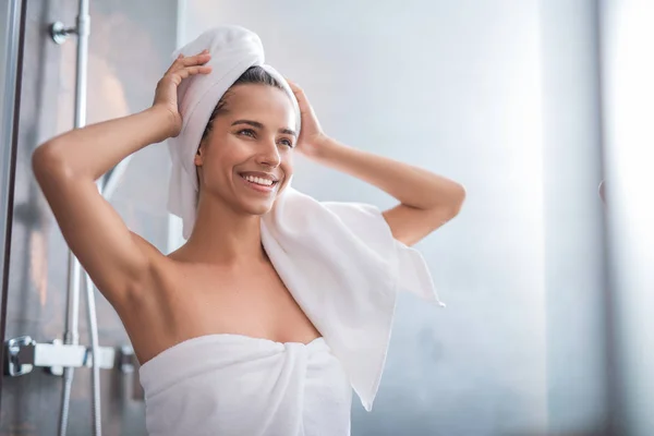 Positive female wrapping in fluffy towel — Stock Photo, Image
