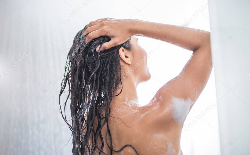 Female washing hair under water
