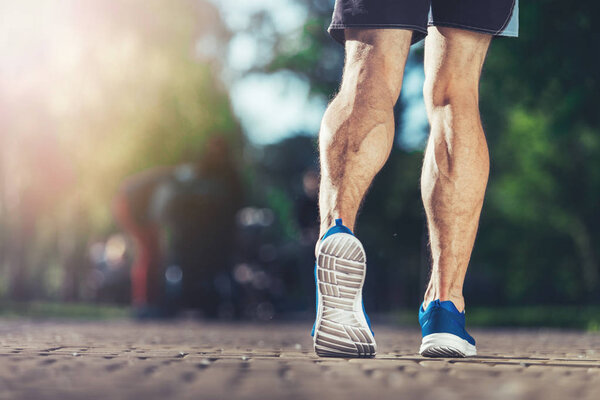 Well shaped athlete jogging in park 