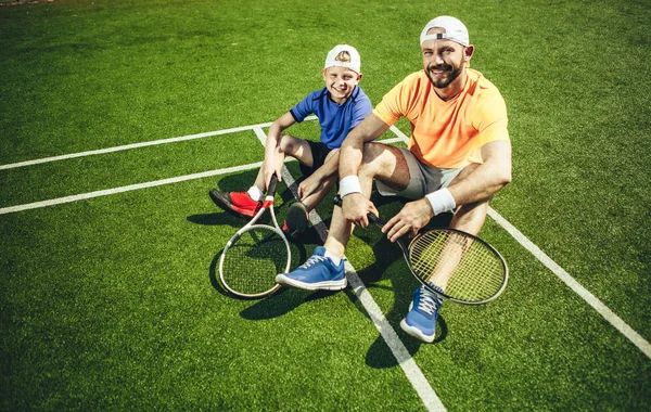 満足の男性と子供のトレーニングの後休憩 — ストック写真